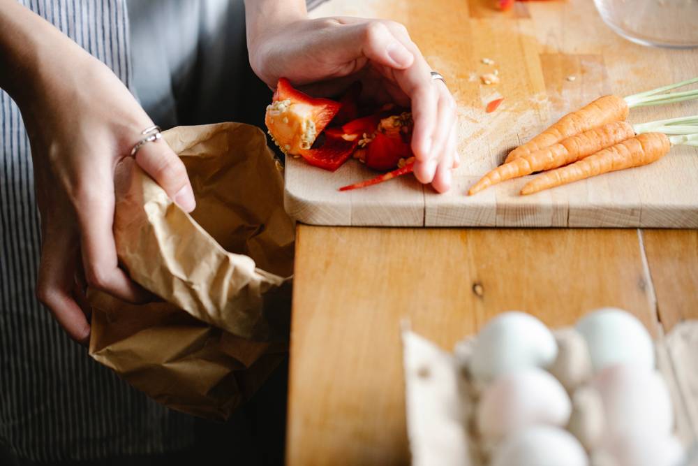 Food waste being thrown in the bin.